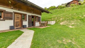 A rustic wooden building with a covered patio and a grassy yard. - Le Petit Riondet - SAINT NICOLAS LA CHAPELLE (SAINT NICOLAS LA CHAPELLE)
