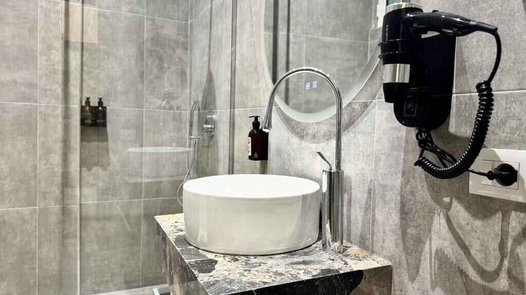 Deluxe-Suite | Badezimmer | Dusche, kostenlose Toilettenartikel, Haartrockner, Hausschuhe
