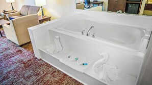 A modern bathroom with a large white bathtub, two sinks, and a mirror above the tub. - Accessible Downtown Stay w/ Free Breakfast, Pool Access & Airport Shuttle (Salt Lake County)