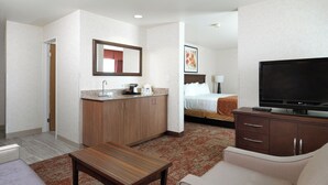 A hotel room with a kitchenette, a bed, a TV, a sofa, and a coffee table. - Pet-Friendly SLC Stay w/ Free Breakfast, Pool Access & Airport Shuttle Service (Salt Lake County)