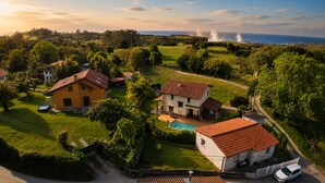 A residential area with houses, a swimming pool, and a view of the sea. - Villa Los Bufones de Pria (Llames De Pria)