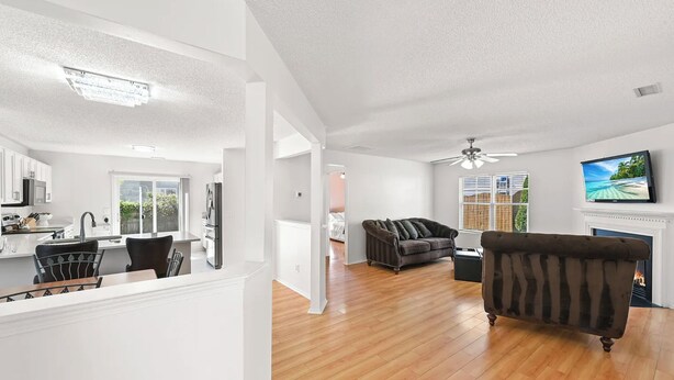 A modern living room with a fireplace, a television, and a sofa.