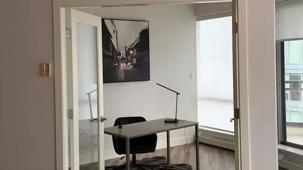 A modern office space with a desk, chair, and a large window. - Breathtaking 20th Floor Skyline Views in the Heart of Downtown Calgary (Calgary)