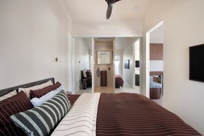 Ein Schlafzimmer mit Bett, Spiegel und Fernseher.