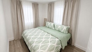 A bedroom with a bed, curtains, and a headboard. -  Cozy coastal stay in Fort Lauderdale near las olas,Wilton manors,airport,Port (Fort Lauderdale)