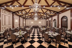 A large banquet hall with high ceilings, chandeliers, and a checkered floor. - Brij Anayra Dharamshala (Dharamshala)