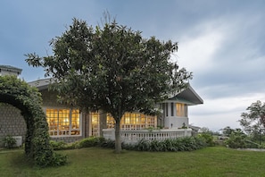 A large building with a prominent tree in the front yard. - Brij Anayra Dharamshala (Dharamshala)