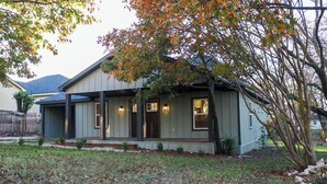 A single-story house with a porch, a small front yard, and a tree with autumn leaves. - The Rustic Charm (Midlothian)