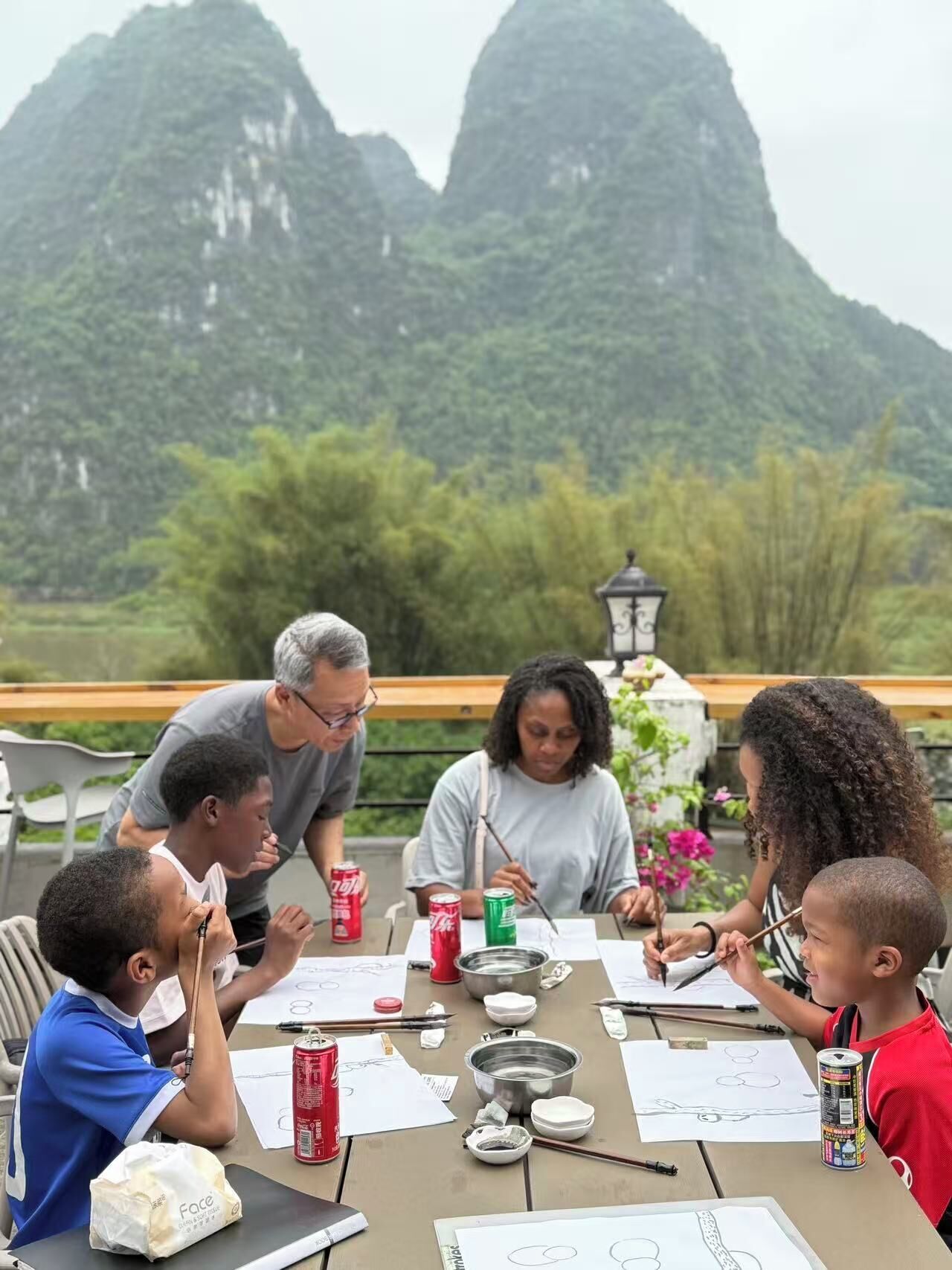 A group of people engaged in an outdoor activity with a scenic mountainous backdrop.