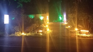 A nighttime scene with a sign reading 'Welcome to Wild' and a small illuminated structure.
