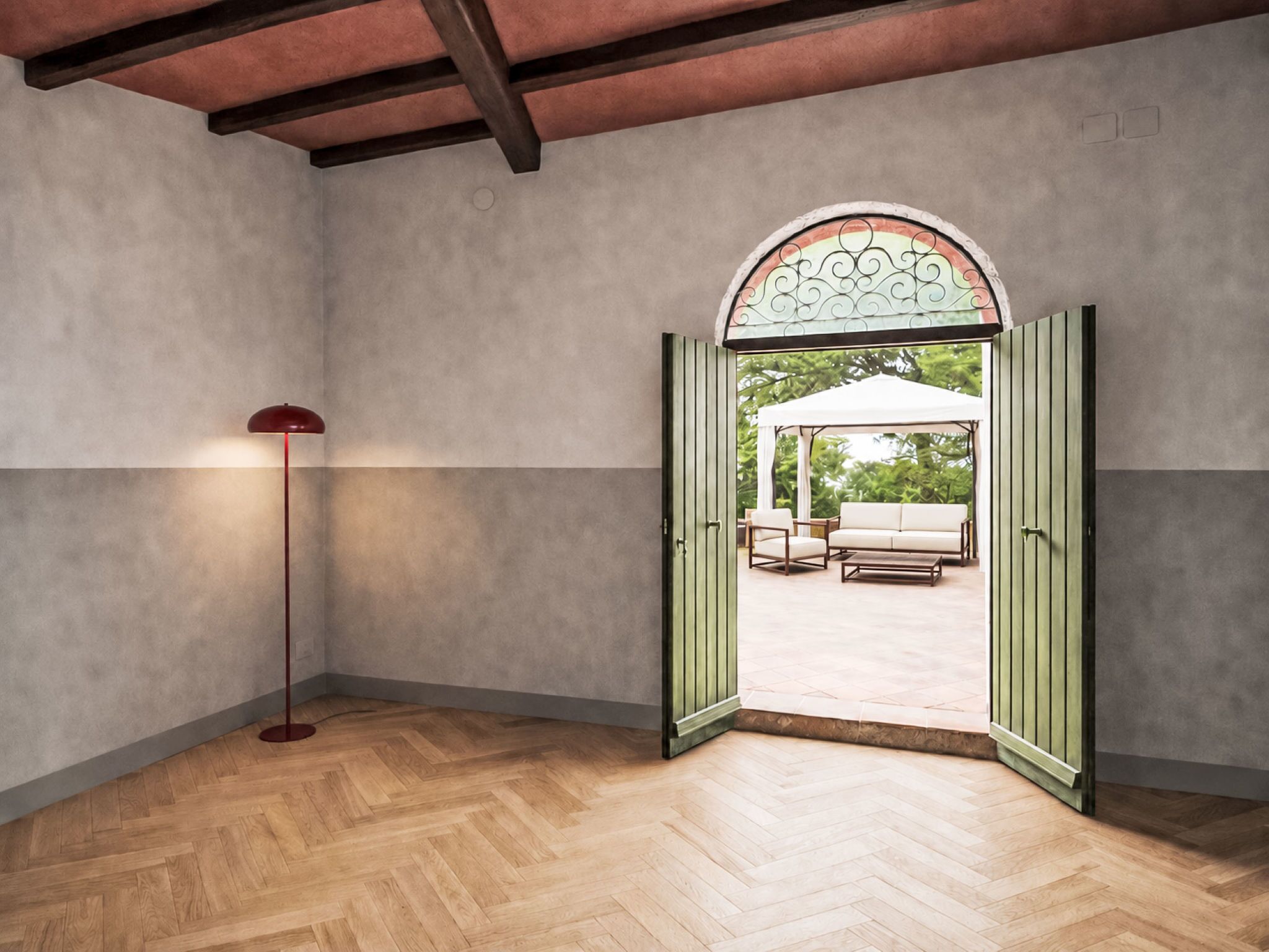 A room with a wooden herringbone floor, a red floor lamp, and a green door leading to an outdoor seating area with a white canopy.