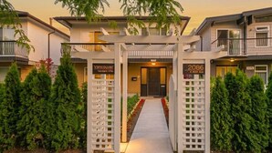 A residential building with a gated entrance, numbered units, and a sign indicating the location as Vancouver, Verdant Ville. - Vancouver Verdant Villa (Vancouver)