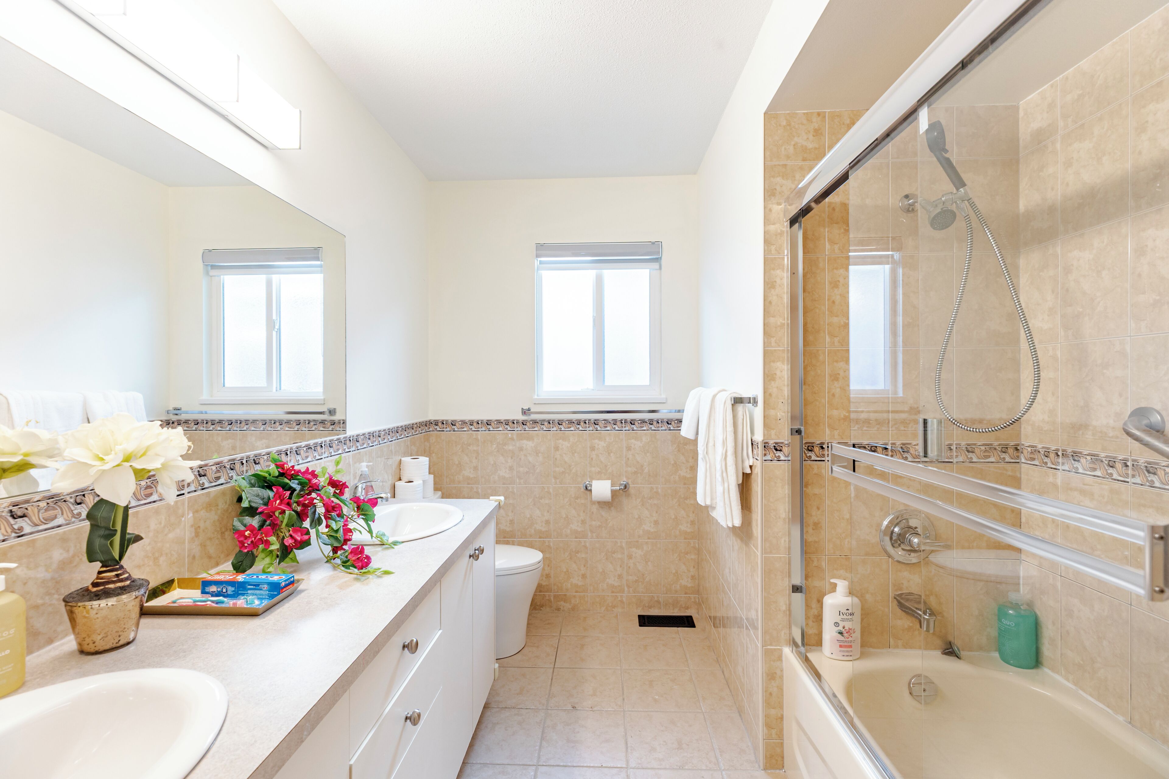 A bathroom with a bathtub, toilet, sink, and shower.