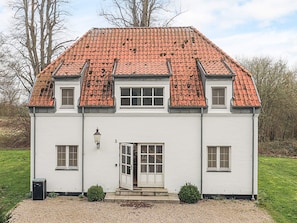 A two-story building with a red-tiled roof, a white exterior, and a small front porch. - 4 Star Holiday Home in Faaborg (Faaborg)