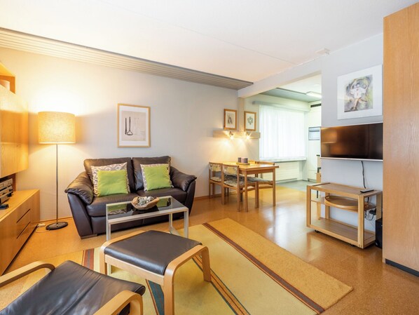 A modern living room with a sofa, coffee table, and TV stand. - Val Signina 7-1 by Interhome (Laax)
