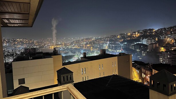 A nighttime cityscape with buildings and a distant view of a city. - 10 Mins to Takism - Central & New Modern Flat (Beyoğlu)