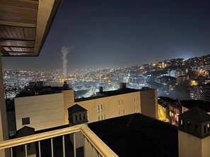 A nighttime cityscape with buildings and a distant view of a city. - 10 Mins to Takism - Central & New Modern Flat (Beyoğlu)