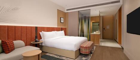 A hotel room with a bed, a sofa, a small round table, a chair, a bathroom, and a TV.