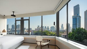 A modern bedroom with a large window, a bed, a chair, and a floor lamp. - SOVIS PLUS HOTEL (Shenzhen)
