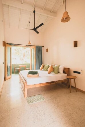 A bedroom with a bed, a ceiling fan, a wicker pendant light, and a view of the outdoors. - Sea Station by Unrushed (Habaraduwa)