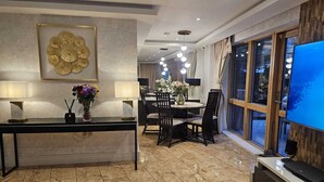 A modern hotel lobby with a reception desk, dining area, and large windows. - Minutes from tube, exclusive central london location. Huge garden and spacious (London)