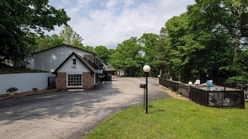 A residential property with a garage, a fenced yard, and a mailbox.