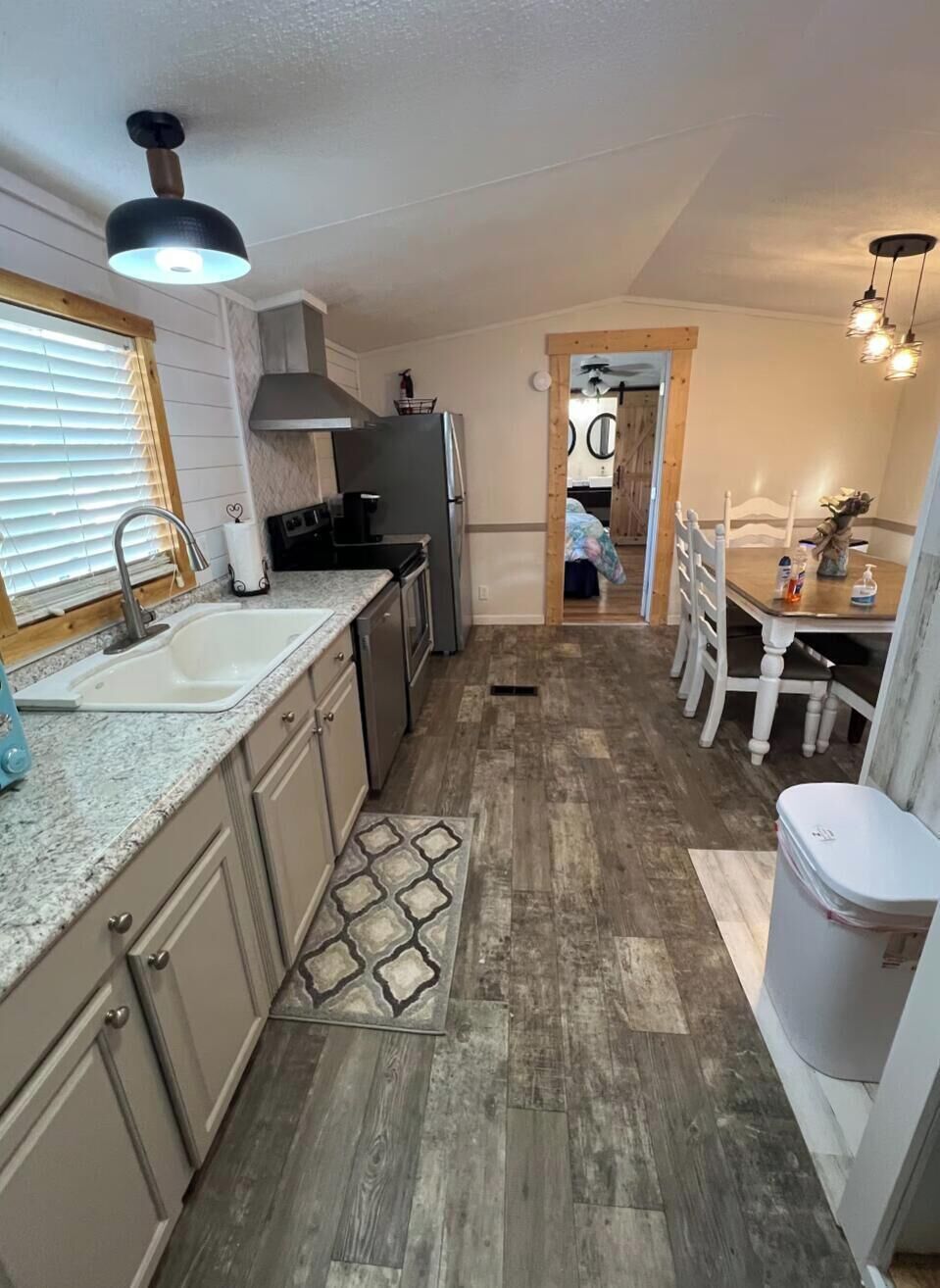 A compact kitchen with a sink, stove, and dining area.