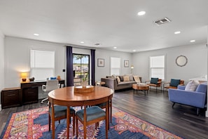 A spacious living room with a dining area, a sofa set, and a coffee table.