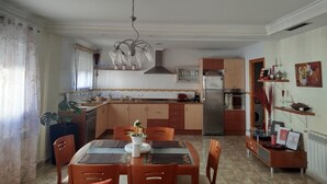 A modern kitchen with a dining area, stainless steel appliances, and a chandelier. - APARTMENT FOR CYCLISTS IN BENISSA, COSTA BLANCA (Benissa)