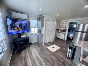A modern kitchen with a built-in oven, microwave, and stainless steel refrigerator. - The Matunuck Coastal Cabin - Beachside Escape Near Restaurants (South Kingstown)