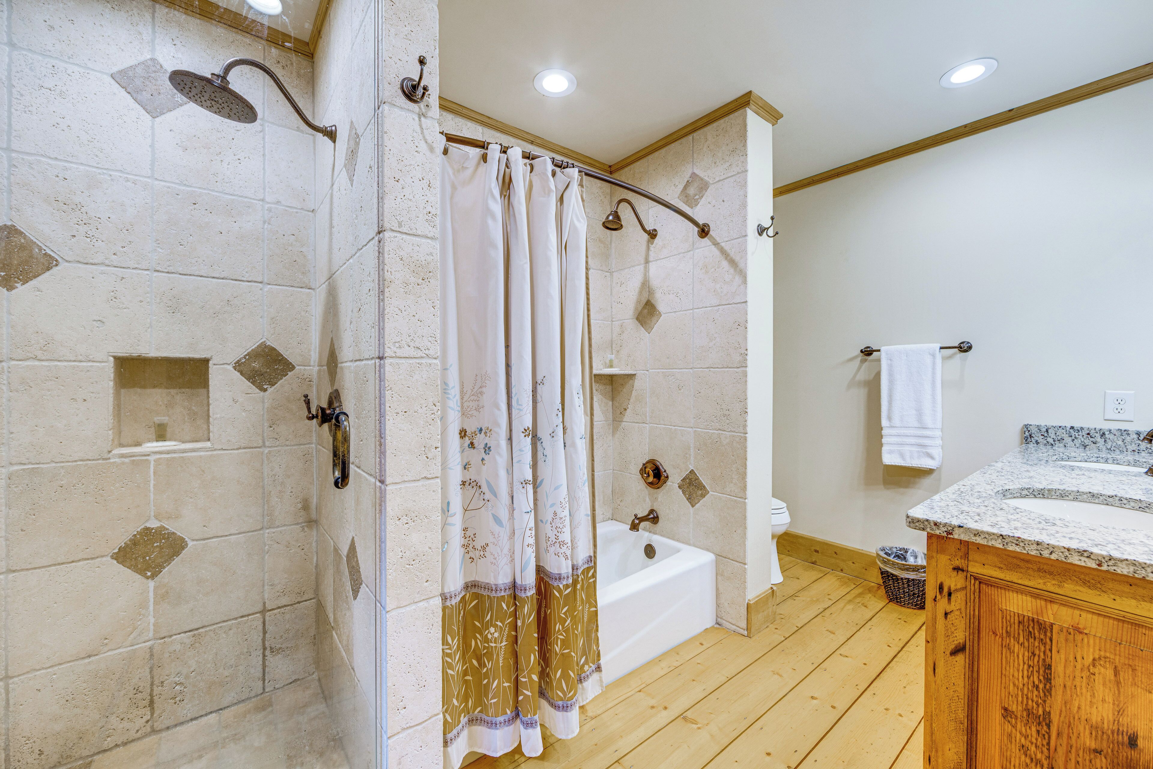 A bathroom with a bathtub, shower curtain, and tiled walls.
