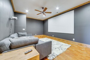 A modern living room with a gray sofa, a white fluffy rug, and a wooden coffee table.