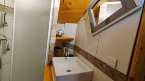 A bathroom with a white sink, wooden countertop, and a mirror. - Chalet Magui, Saint-sorlin-d\"arves (Saint-Sorlin-d'Arves)