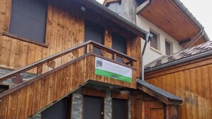 A wooden building with a balcony, stone steps, and a sign that reads 'CHALLET MAGUIR.' - Chalet Magui, Saint-sorlin-d\"arves (Saint-Sorlin-d'Arves)
