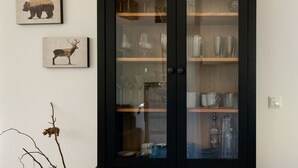 A cabinet with glass doors containing various glassware and decorative items. - WaldLoft - Southern Styria (Heimschuh)