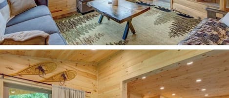 A cabin interior with a sofa, coffee table, TV, and a fireplace.