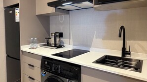 A compact kitchen with a microwave, sink, dishwasher, and refrigerator. - 306 Tara-jre 2bedroom at Jabal Al Lweibdeh (Amman)