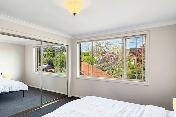 Bright bedroom with mirrored wardrobe