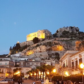 A historic building on a hill with a street below. - Wonderful private villa for 10 people with WIFI, private pool, A/C, TV, patio and pets allowed (Marina Di Ragusa)