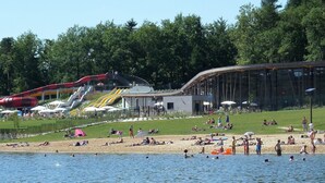 A lakeside resort with a swimming area, a water slide, and a covered pavilion. - Quiet house - Near the lake of Saint-Pardoux (Compreignac)