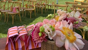 An outdoor event with tables, chairs, and umbrellas.