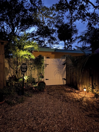 A gated entrance with a sign indicating reserved parking for Paradise Found.. Jupiter Inlet room, walk to everything