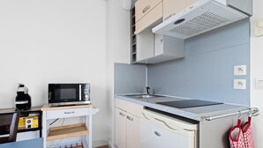 A compact kitchen with a microwave, kettle, and a small countertop. - Riviera Retreat in Grasse (Grasse)