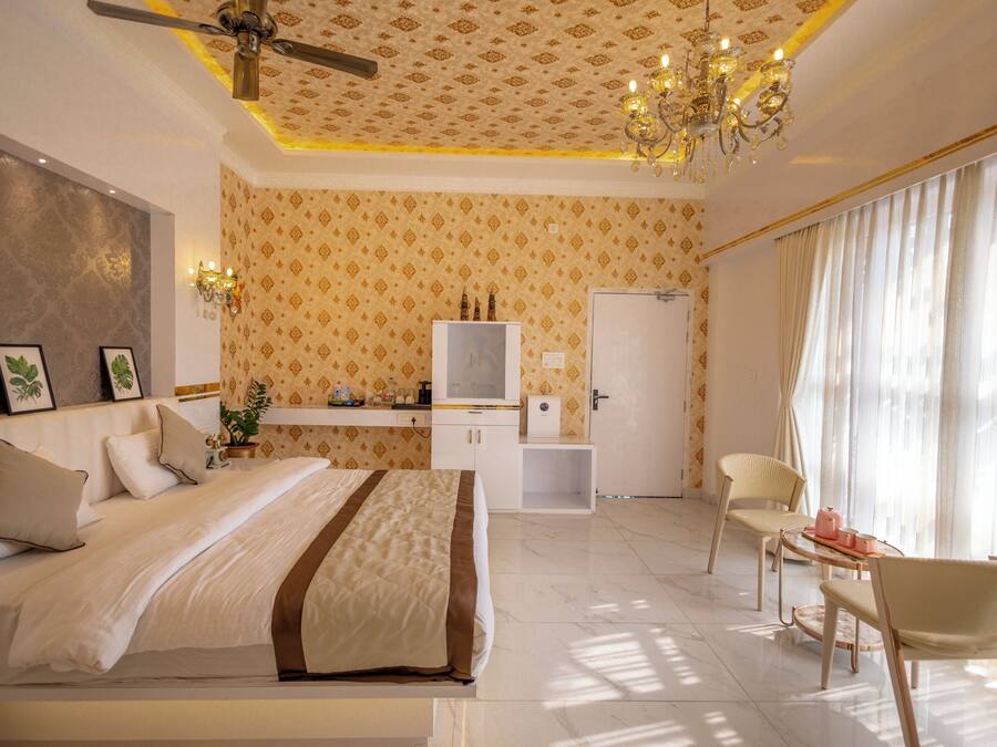 A bedroom with a bed, bedside table, and a desk with a chair.