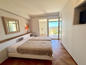 A hotel room with two beds, a bathroom, a TV, and a balcony with a view. - Calm apartment with AC - 4 guests (Saint-Cyr-sur-Mer)