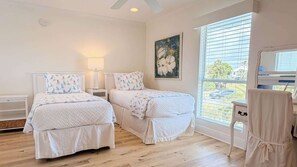 A bedroom with two beds, a painting, a window with blinds, and a ceiling fan. - Quiet Family Home | Close to Beach, Restaurants, Boating | Daily Activity Deals (Orange Beach)