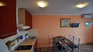 A kitchen with a dining table and chairs, a sink, and a microwave. - Nice Apartment With Terrace and Outdoor Kitchen and sea View ! (Opatija)