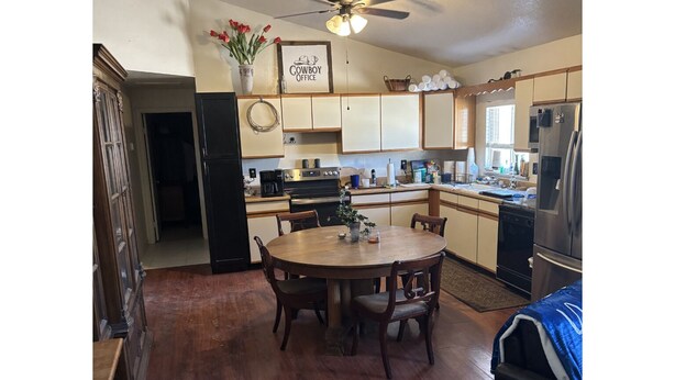 A kitchen with a dining table, chairs, a ceiling fan, and a refrigerator. - Cancer patients that need peace, quiet, support & proximity to treatment plans. (Cave Creek)