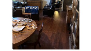 A living room with a television, a ceiling fan, a dining table with chairs, and a sign reading 'Dygerst Trail'. - Cancer patients that need peace, quiet, support & proximity to treatment plans. (Cave Creek)
