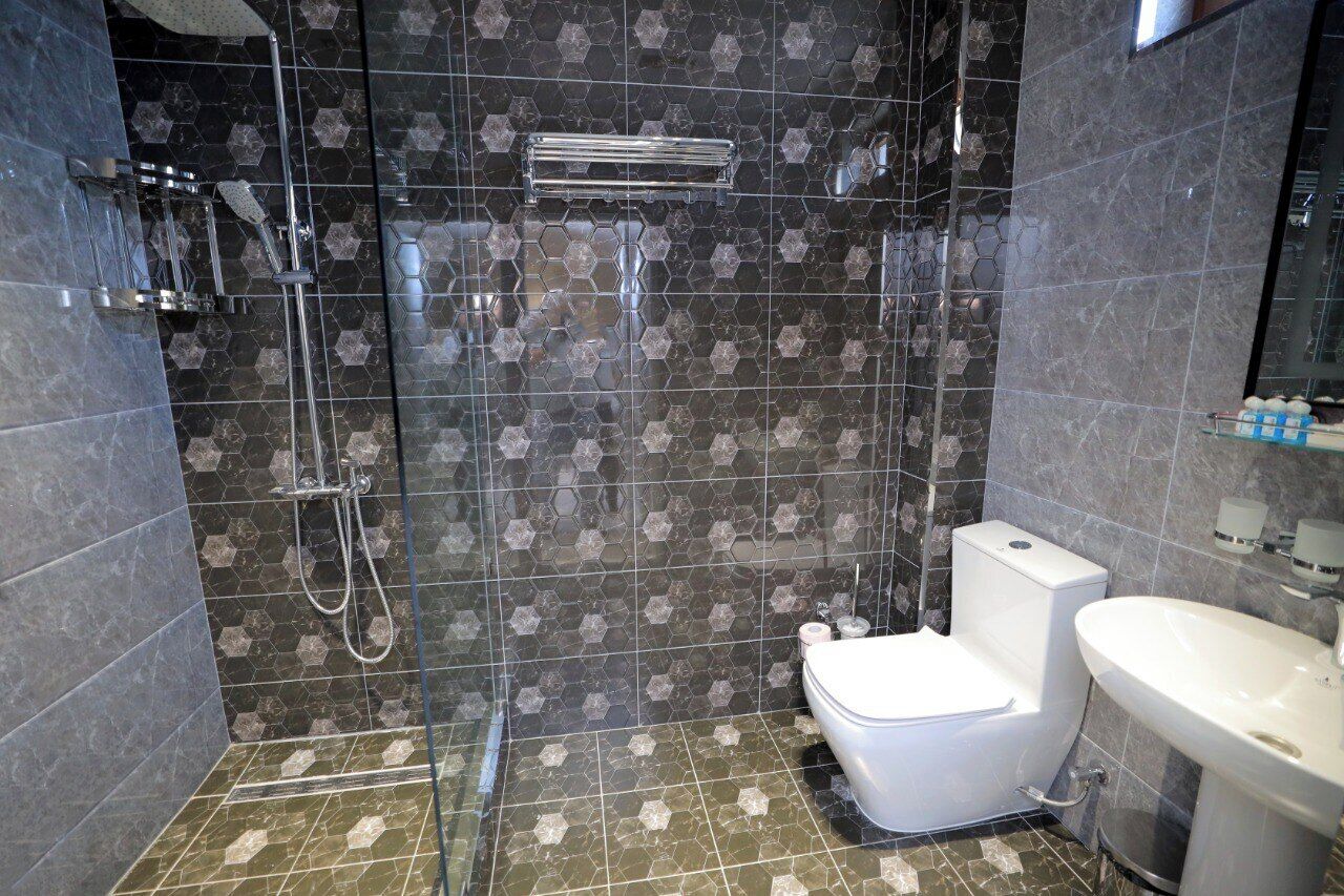 Shower, hair dryer, slippers, towels